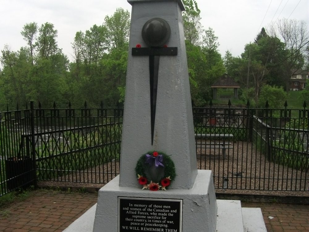 The Manotick war memorial cenotaph with a wreath, in Manotick Remembrance Park
